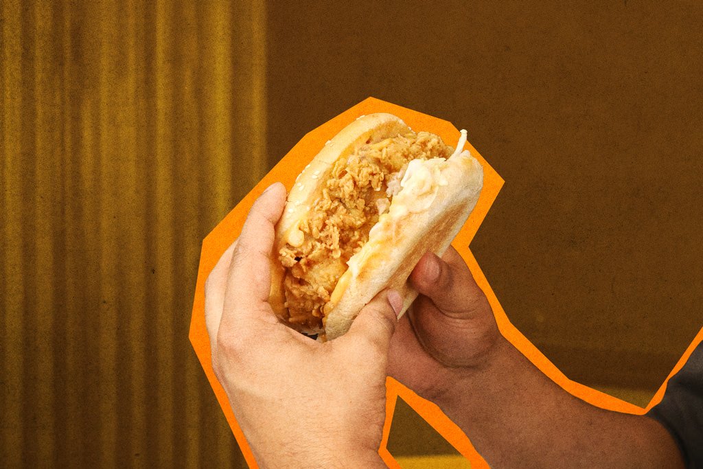 Hand holding an Ollies fried chicken burger
