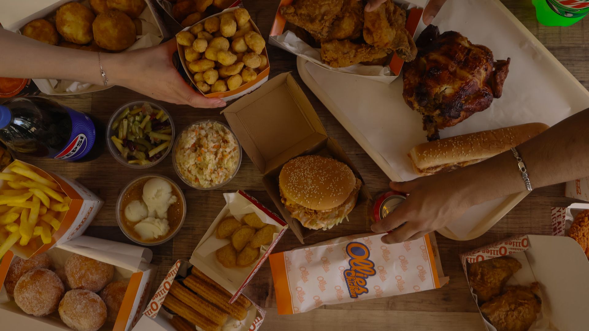 Spread of Ollies fried chicken, burgers, chips and sides